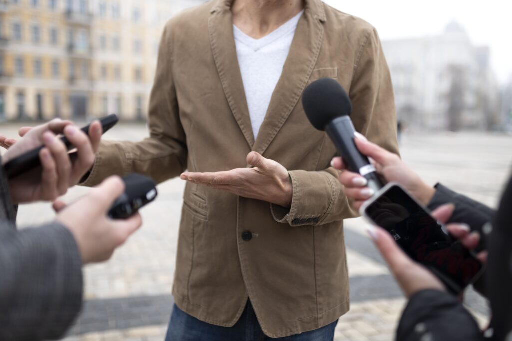 Pessoa sendo entrevistada por um jornalista, ilustrando a importância de preparar clientes para entrevistas e garantir uma comunicação clara e segura com a imprensa.